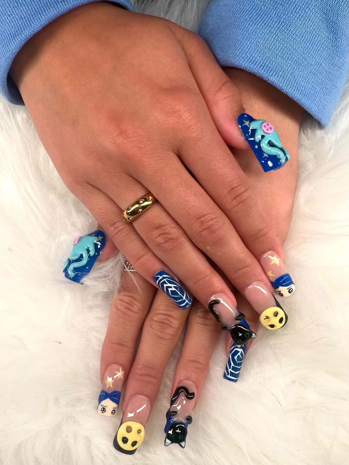 Custom blue character nail art with 3D details on Gel X nails in Thompson